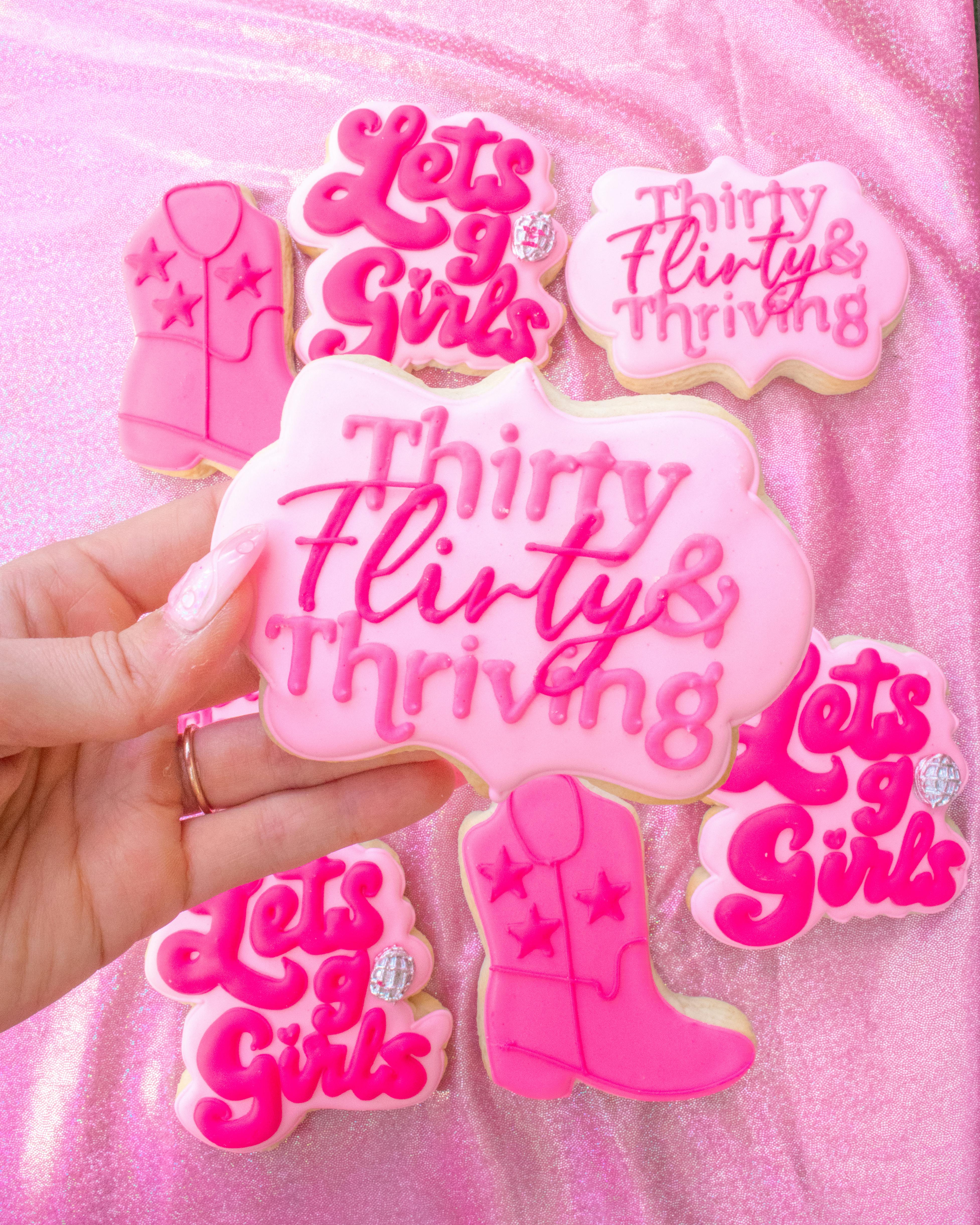 Vibrant pink decorated cookies with 'Thirty Flirty & Thriving' theme. Perfect for celebrations.