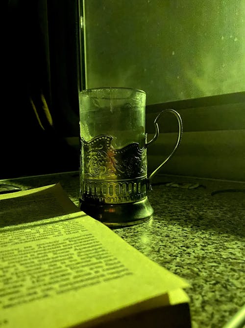 A book and a glass of water on a table