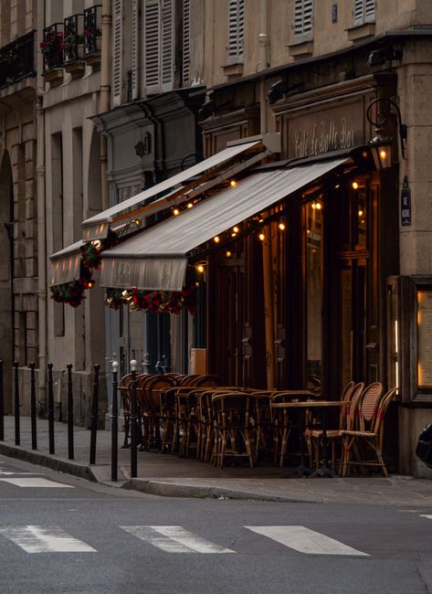 Inviting Paris café with classic chairs and warm lighting on a quiet street corner.