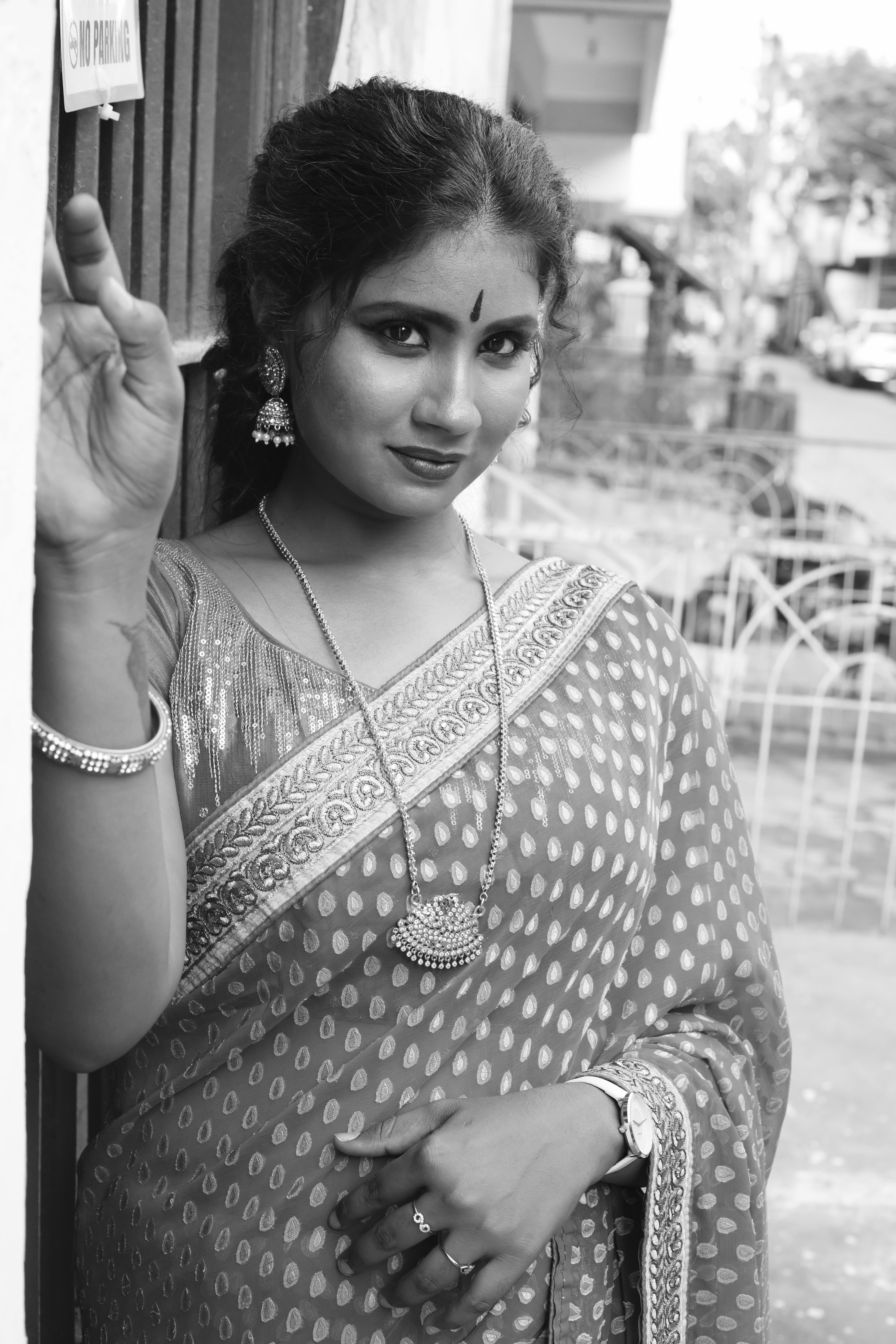 Black and white portrait of a South Asian woman wearing a sari, showcasing cultural elegance.