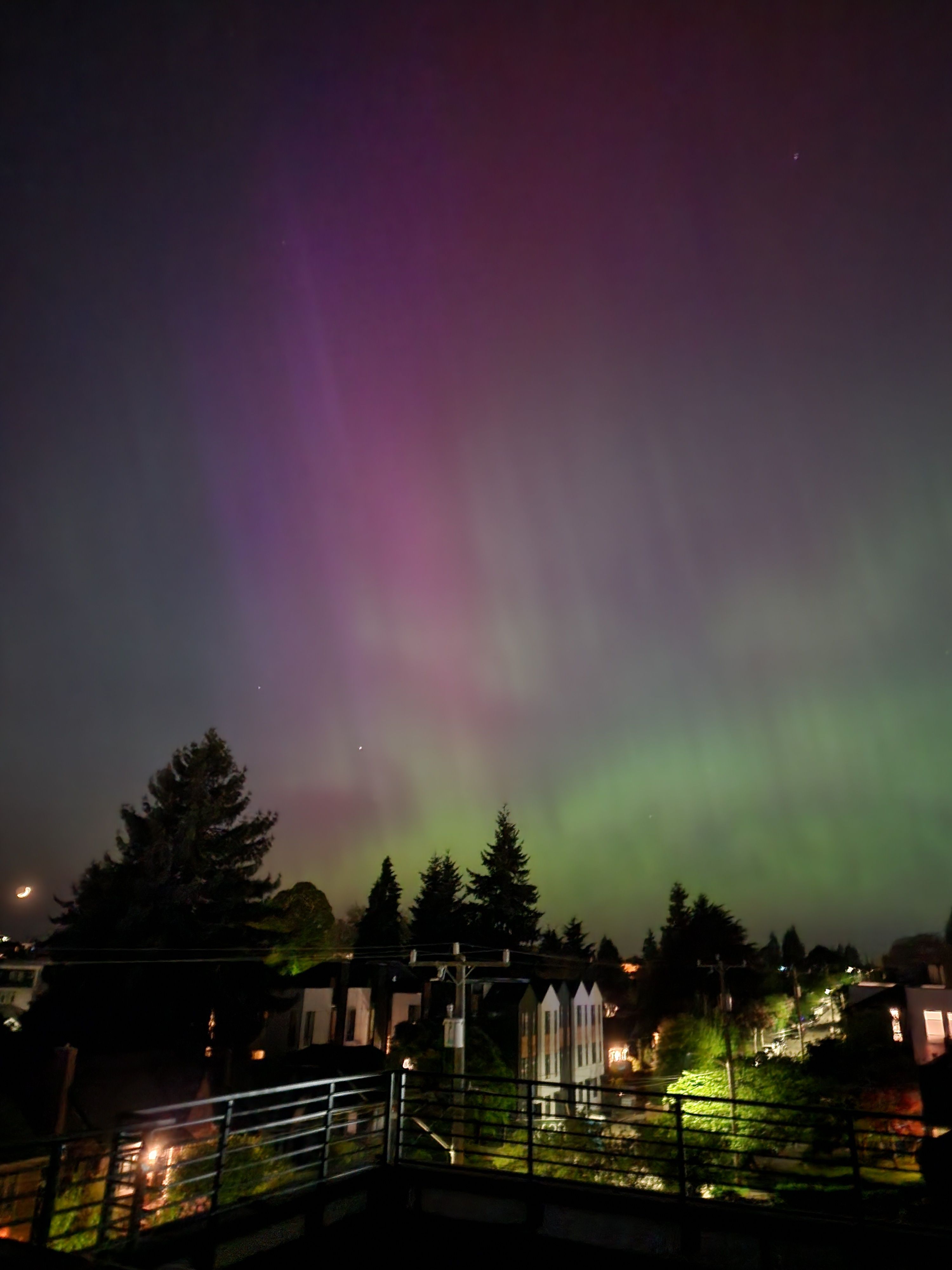 The aurora borealis is seen in the sky above a city · Free Stock Photo