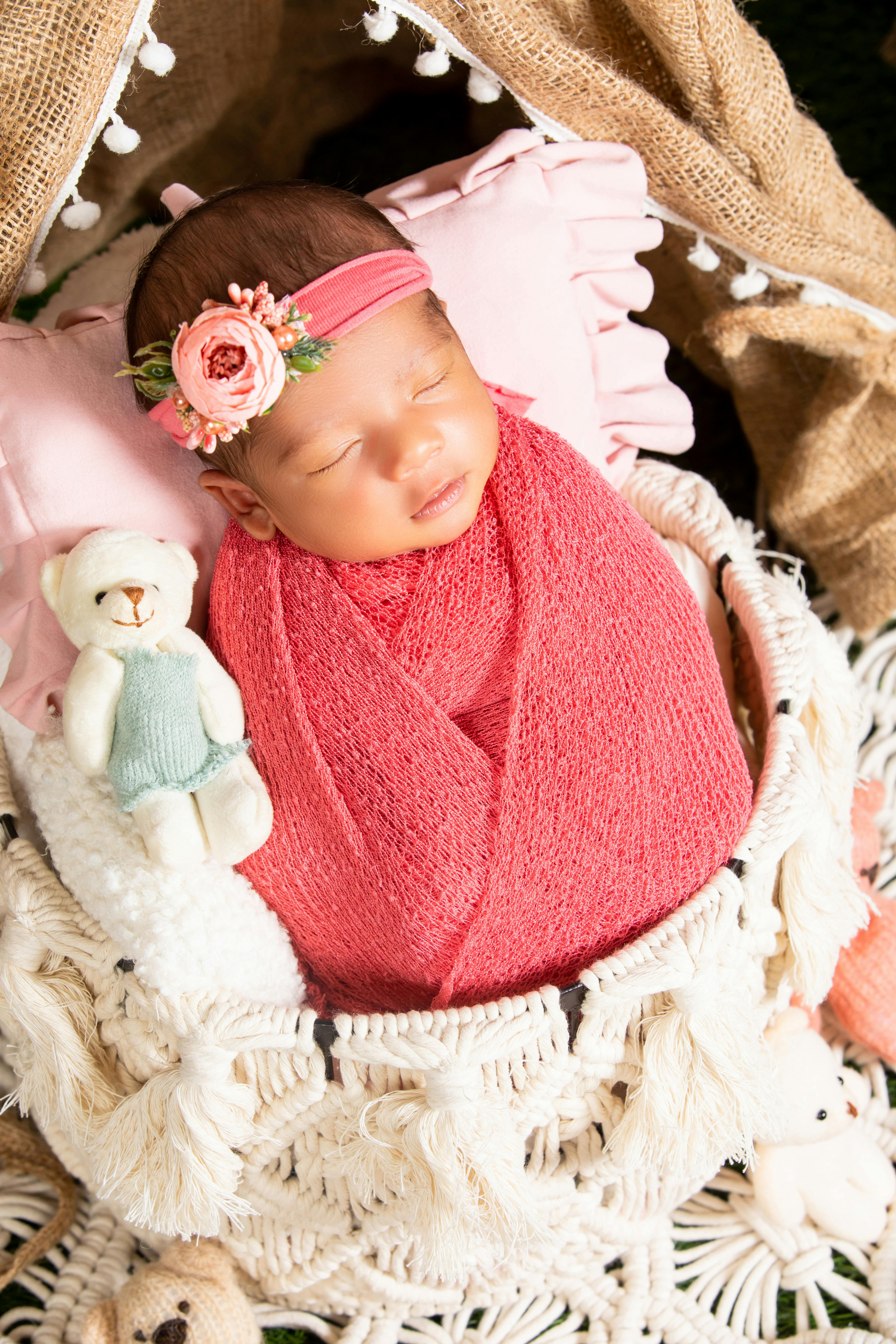 a newborn baby girl wrapped in a pink blanket