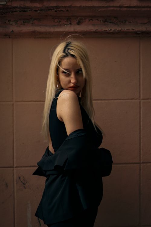 Free Elegant portrait of a blonde woman wearing black, exuding confidence and style. Stock Photo