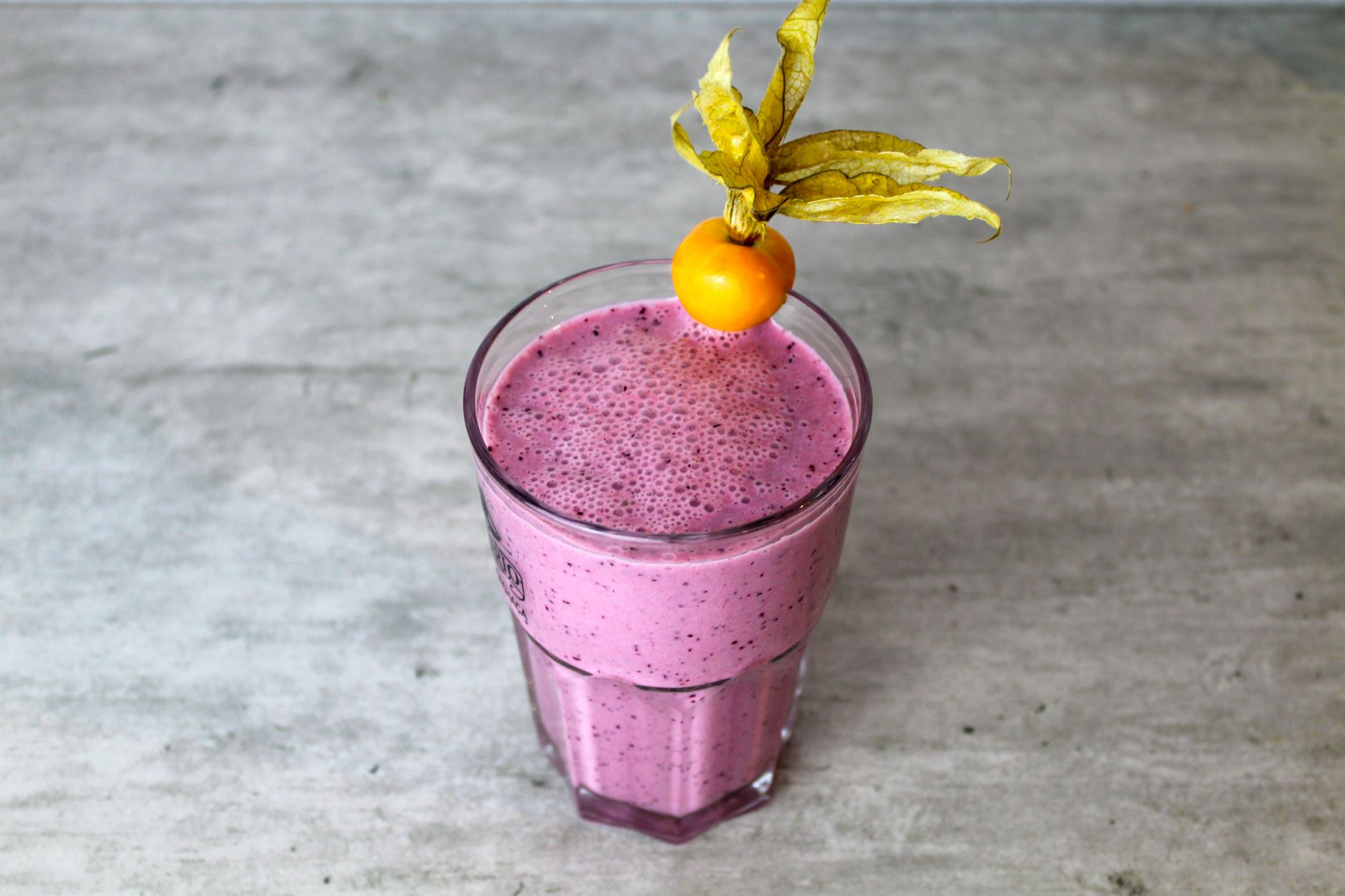 Person preparing a protein shake at home in the kitchen