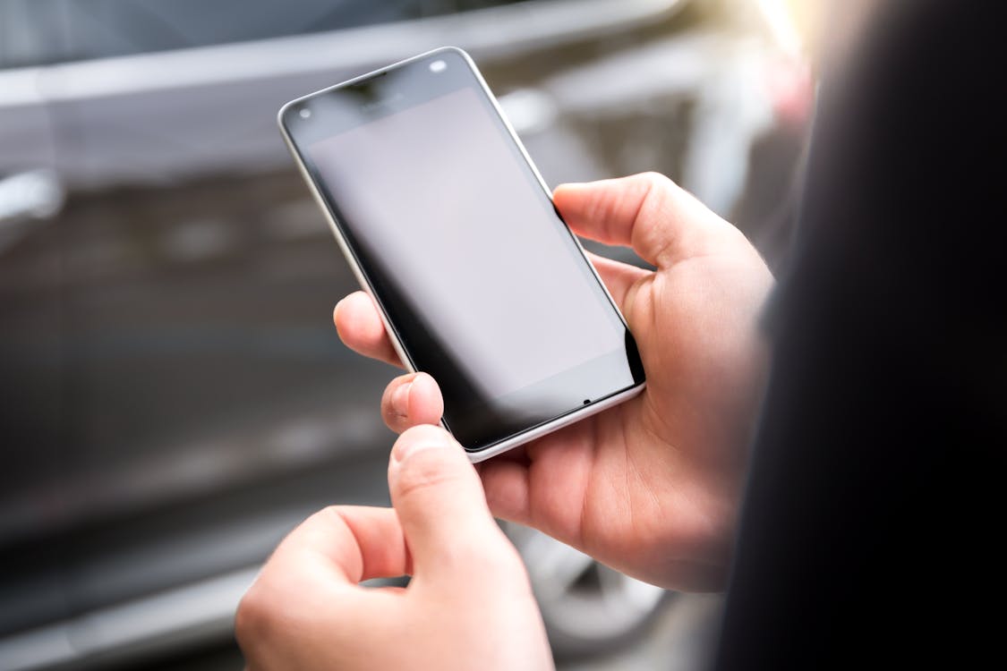 Person Holding Android Smartphone Displaying Black Screen