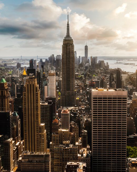 Stunning aerial view of New York City skyline featuring the iconic Empire State Building and surrounding skyscrapers.