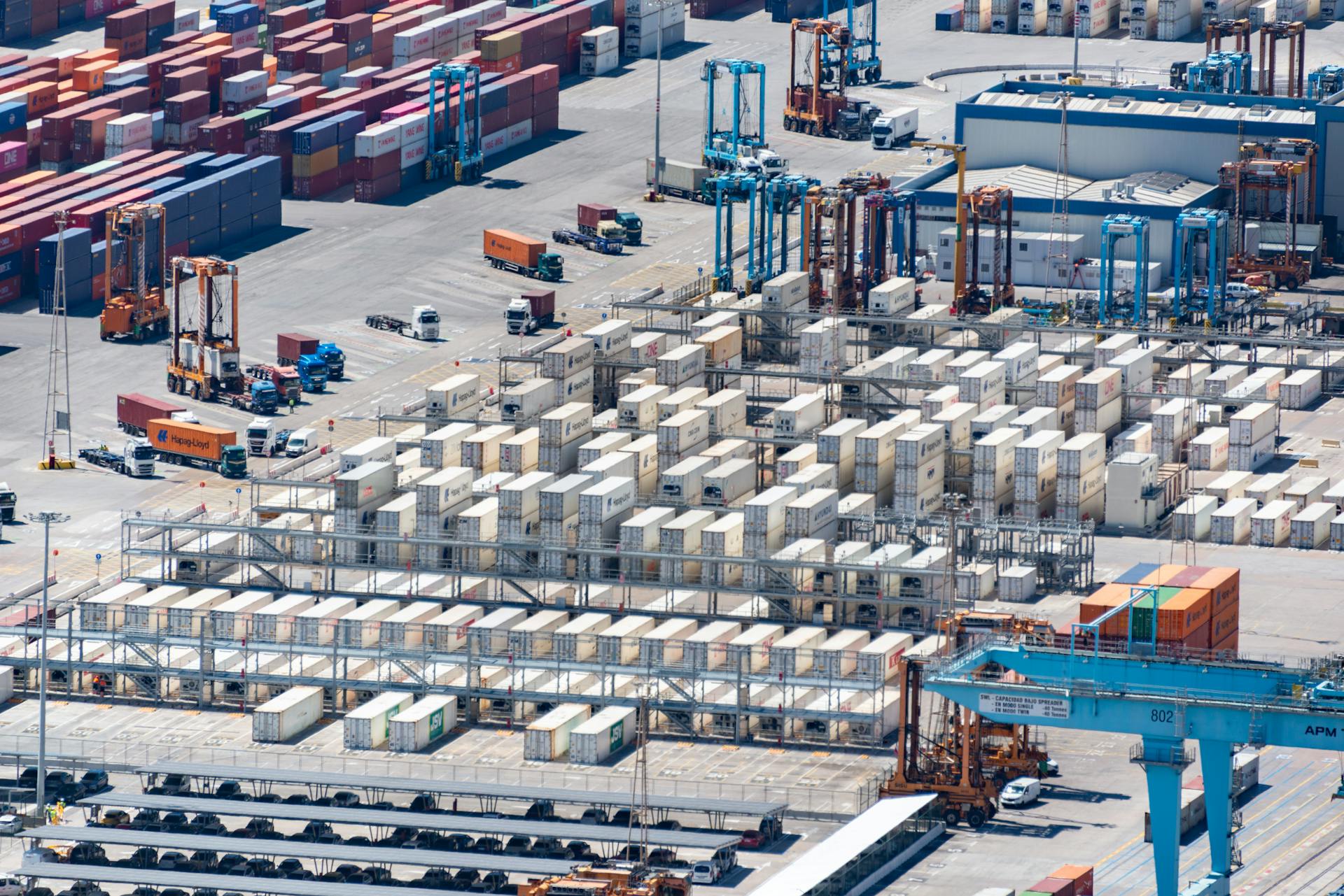 Aerial View of Containers and Machinery in a Port