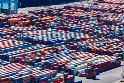 A bustling port with colorful cargo containers, aerial view showcasing global trade.
