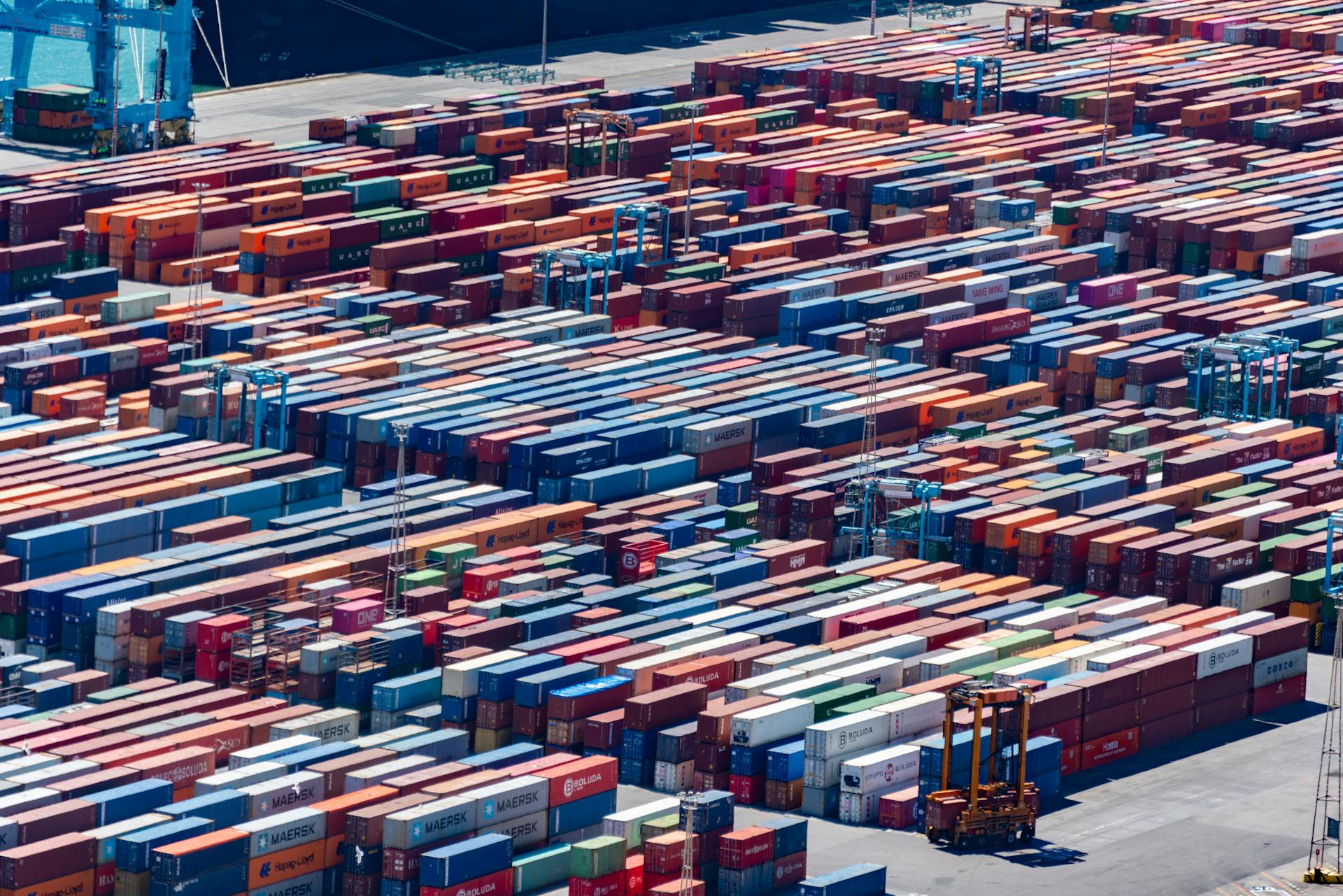 A bustling port with colorful cargo containers, aerial view showcasing global trade.