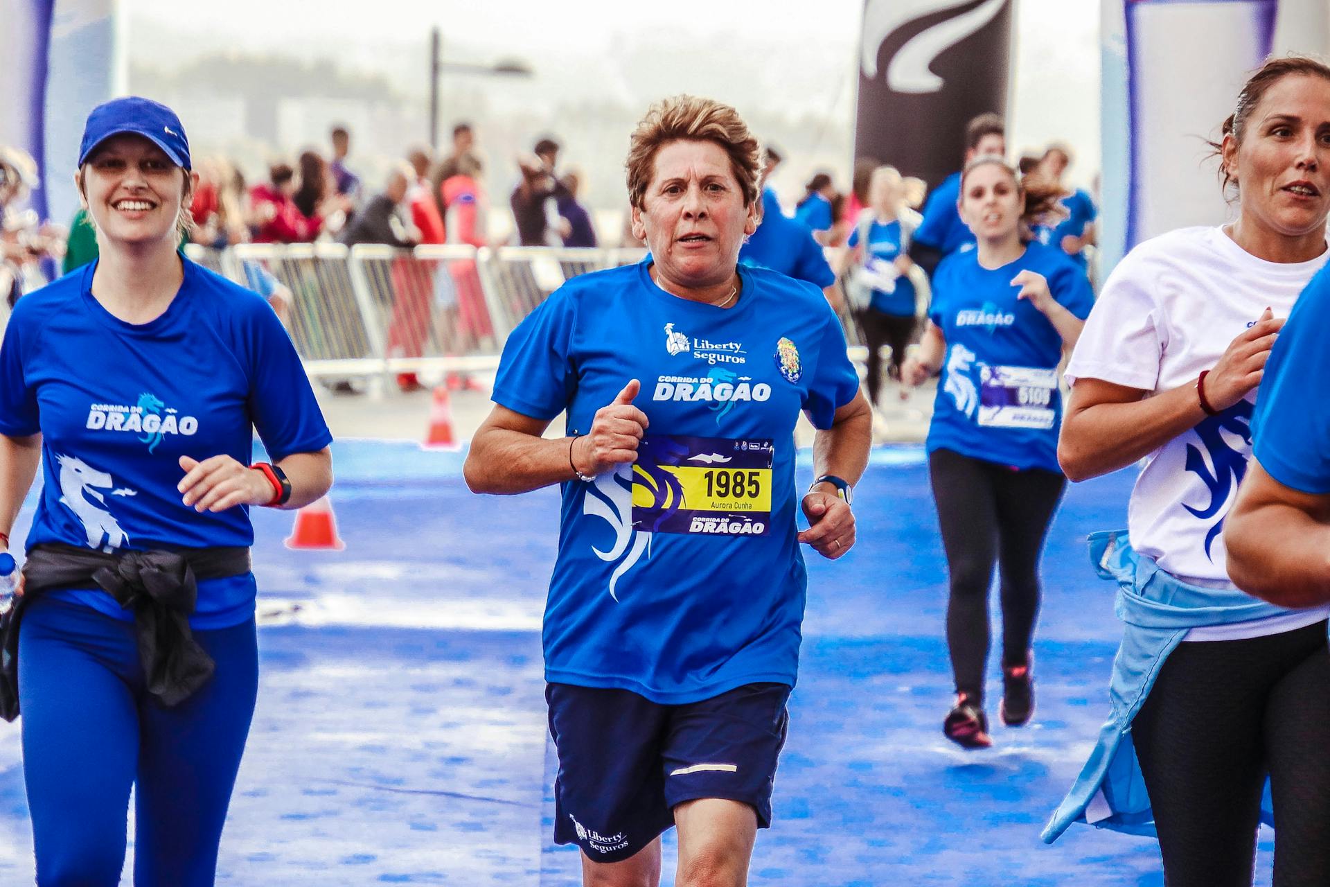 Energetic participants running in a marathon event with a bright blue theme.