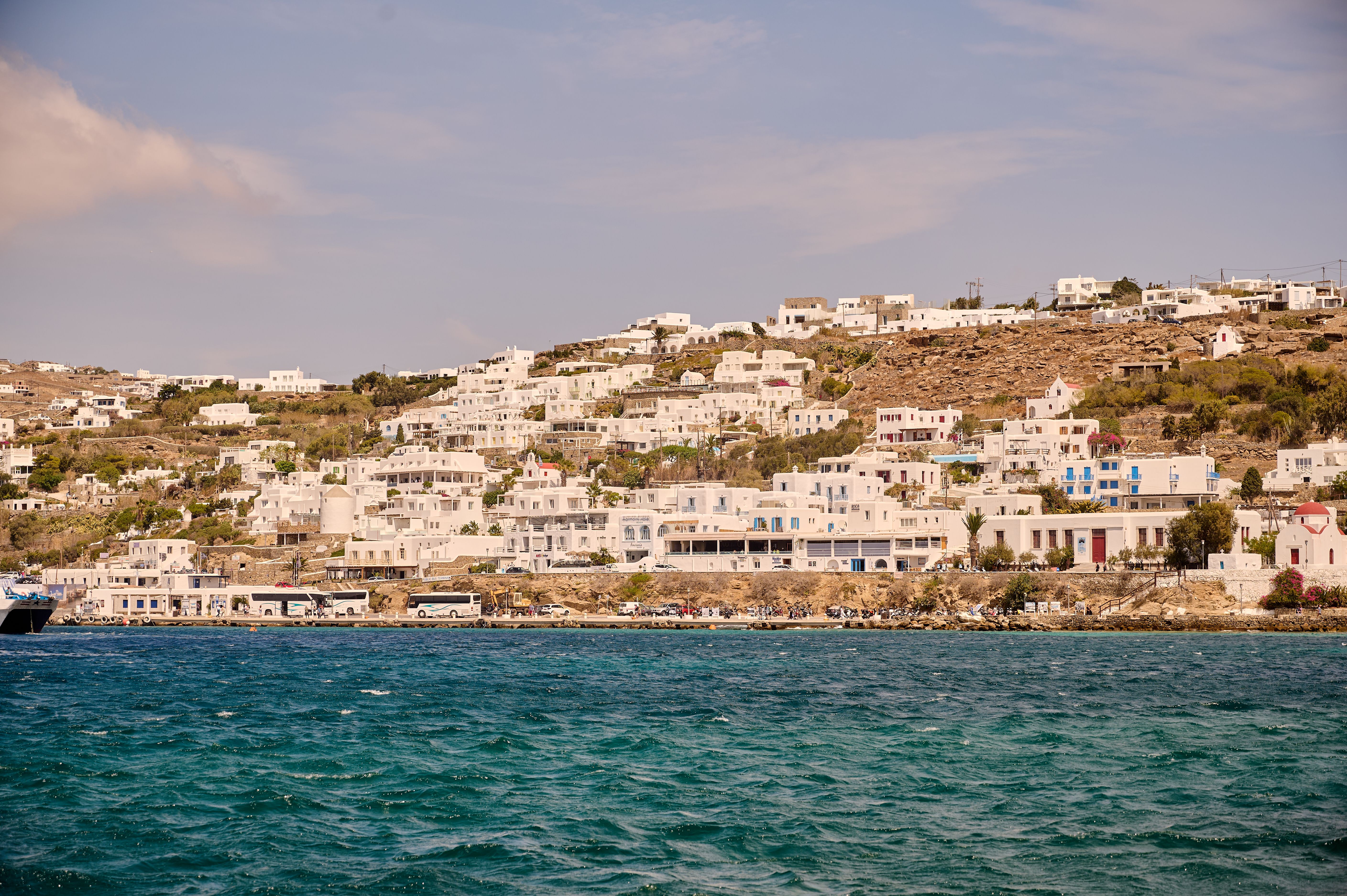 Free Beautiful hillside view of Mykonos Island with traditional Greek architecture by the sea. Stock Photo
