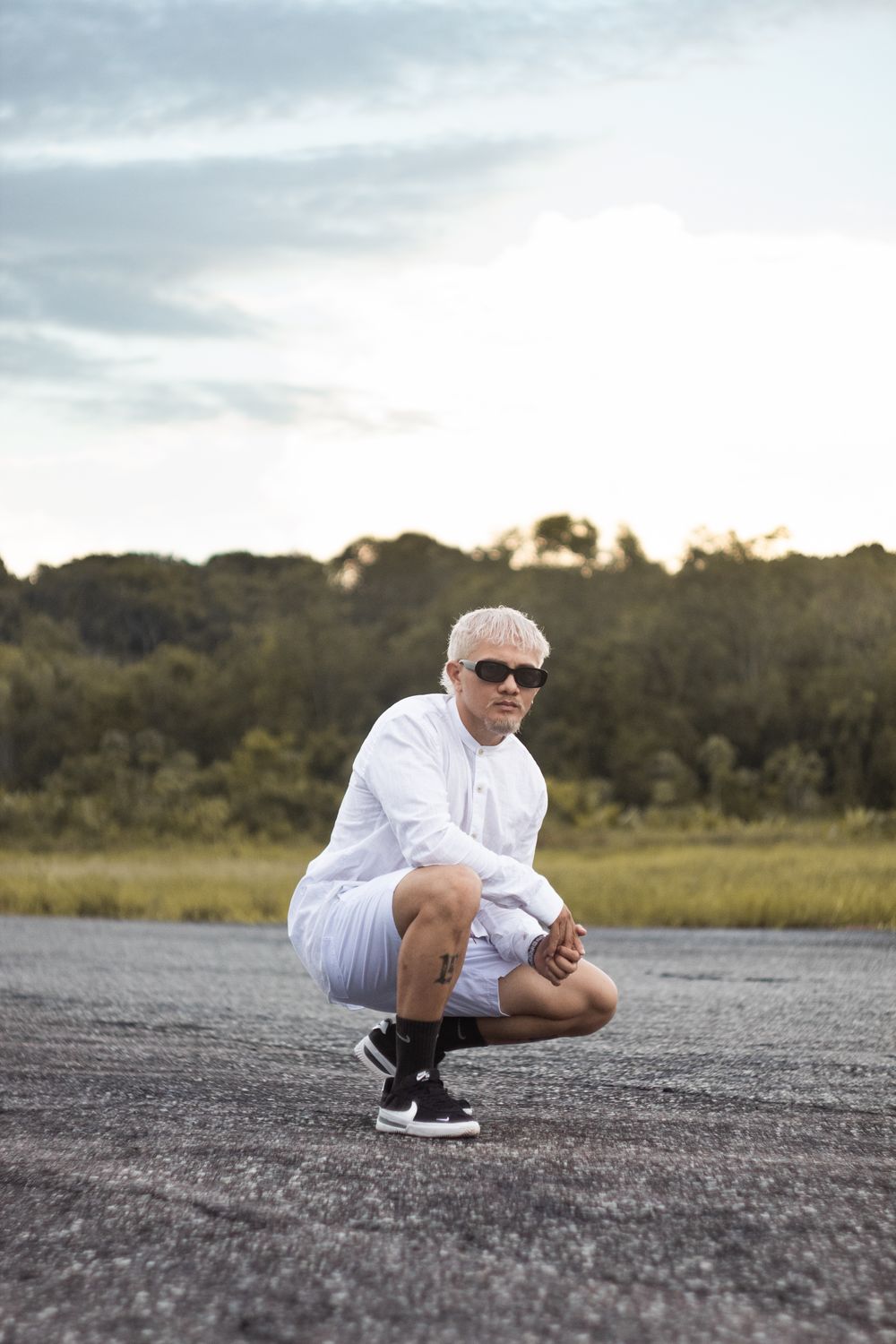 A Man Squatting on the Road · Free Stock Photo