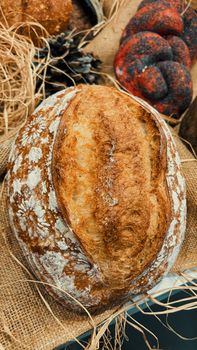 Freshly baked artisan bread loaf on a textured burlap surface, showcasing its rustic appeal.