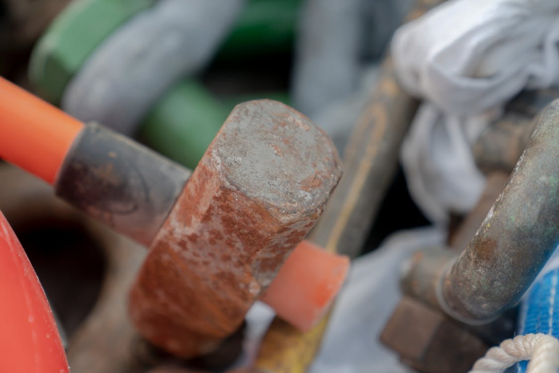 A close-up of a hammer and various construction tools, illustrating the essential gear for construction work.  Close-up of a hammer and various construction tools.