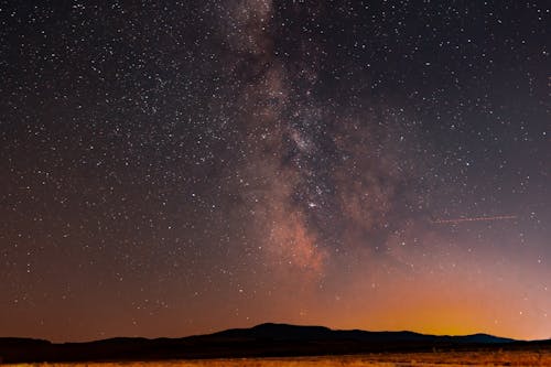 milky way constelation orange sky with  stars