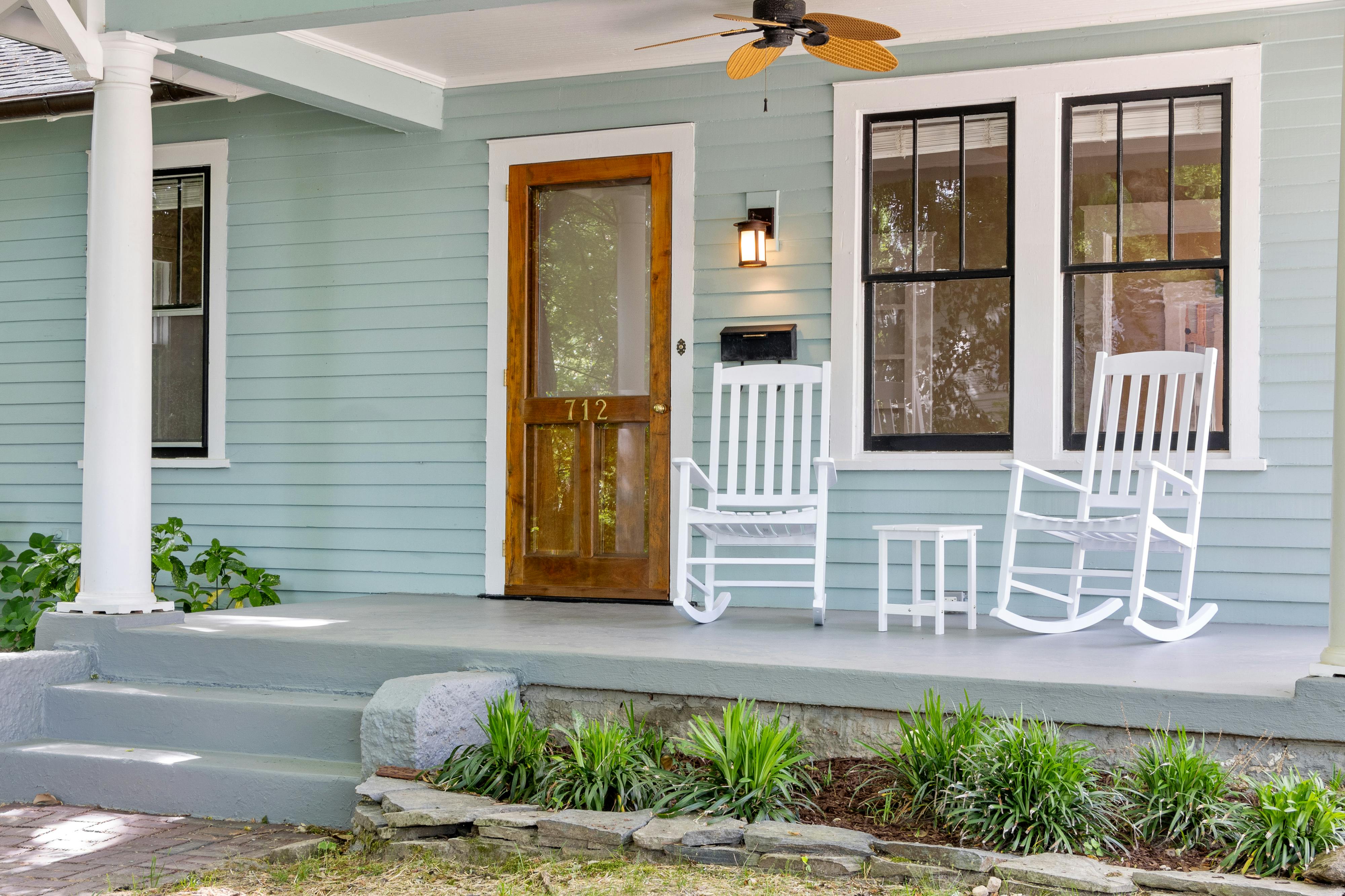 White farmhouse porch with rocking chairs and blue ceiling - covered front porch ideas