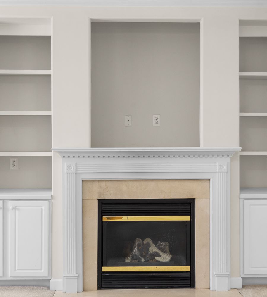 Finished built-in shelving flanking a fireplace
