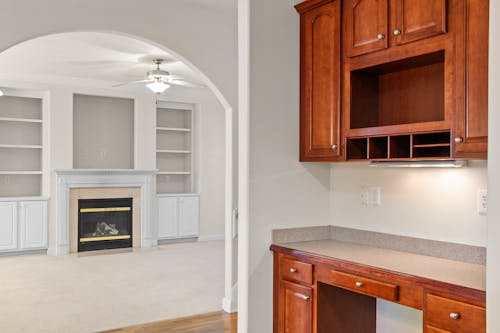 A kitchen with cabinets and a fireplace