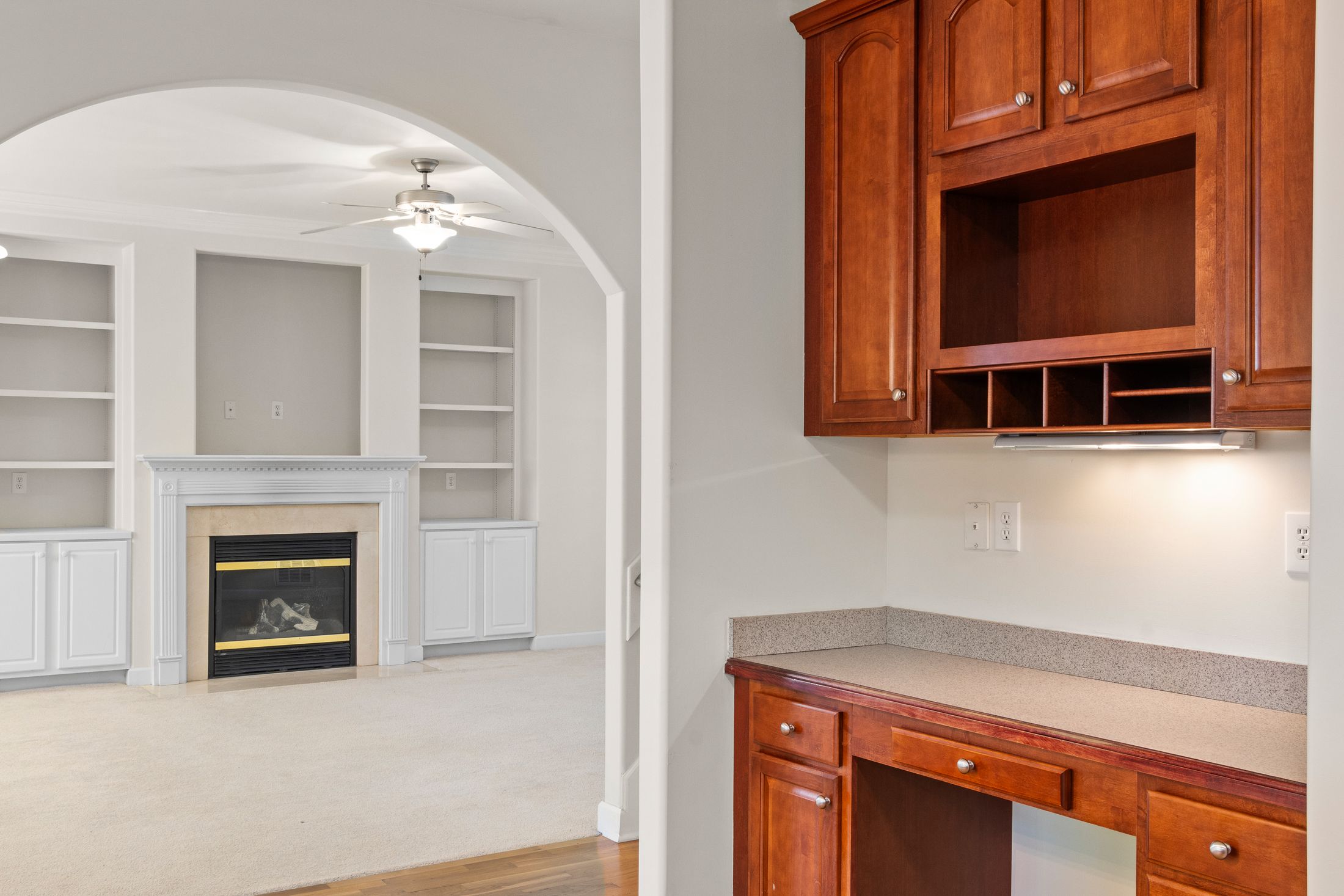 Built-in cupboards around an arched opening