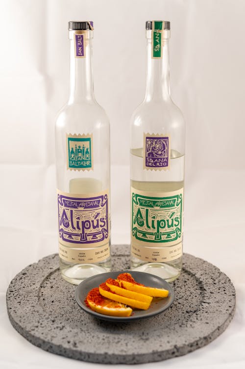 Two bottles of alpaca liquor on a plate