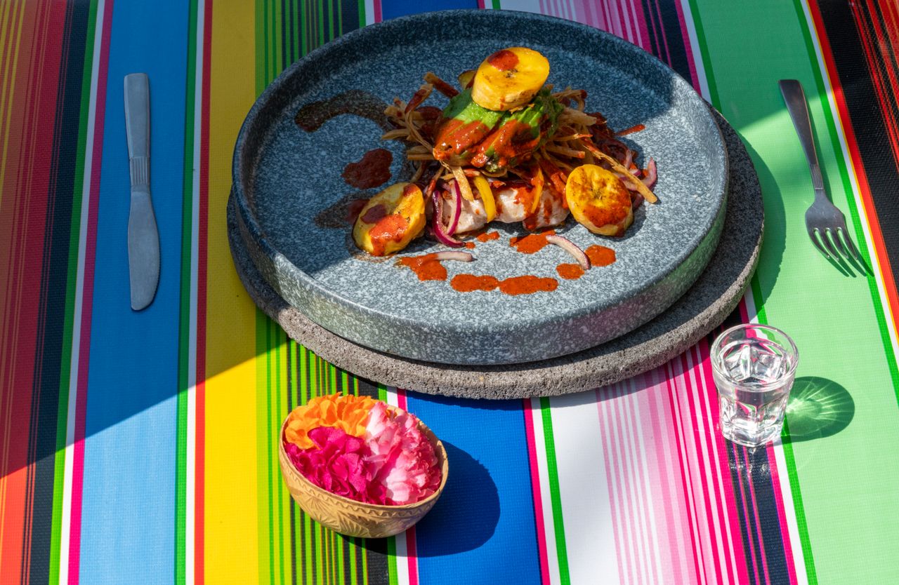 colorful mexican meal setting with vibrant tablecloth and dish in mexi