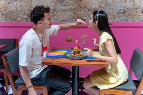 Free A young couple sharing a meal at a colorful restaurant in Mexico City, CDMX. Stock Photo