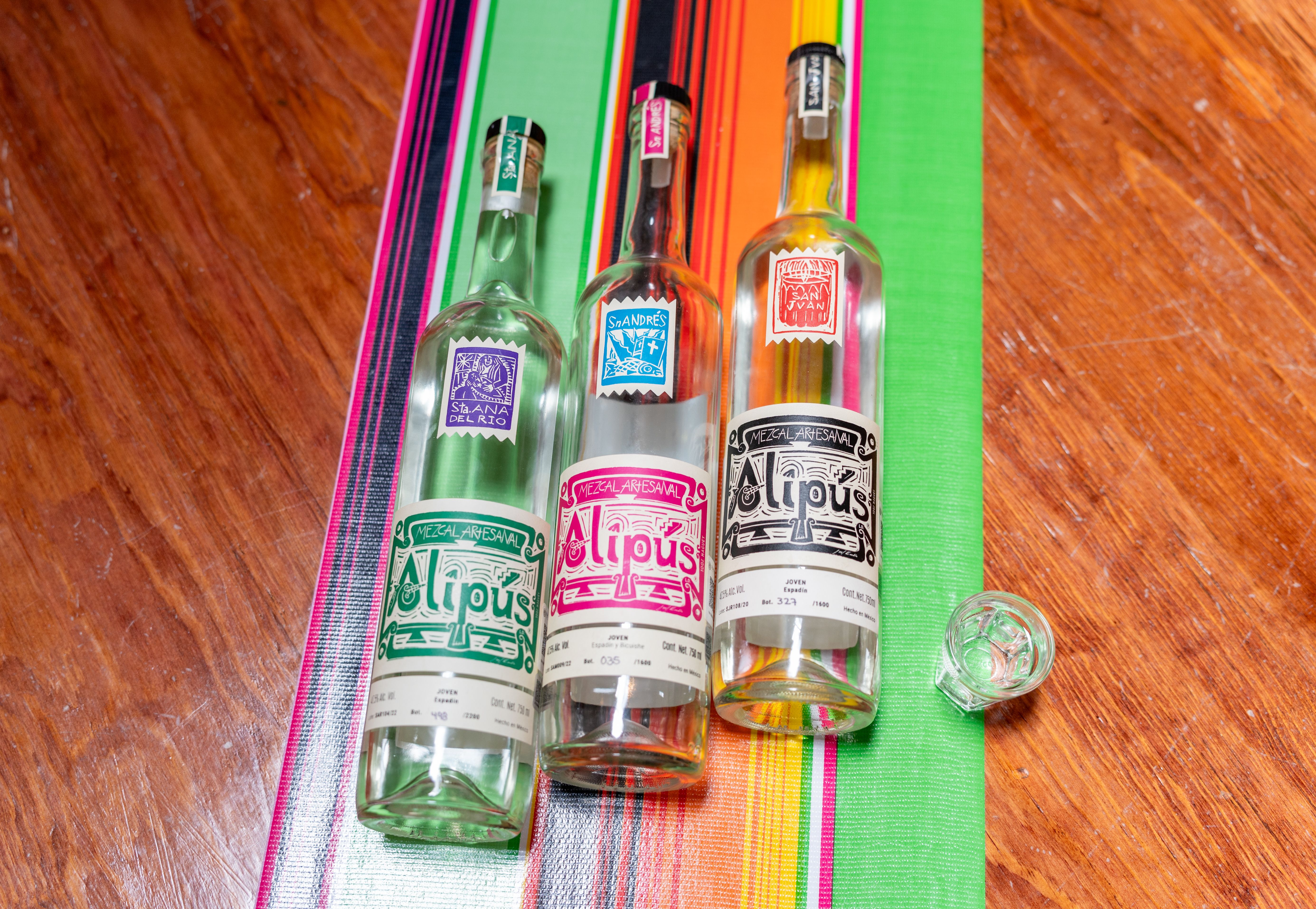 Bottles of Mexican spirits on wooden table