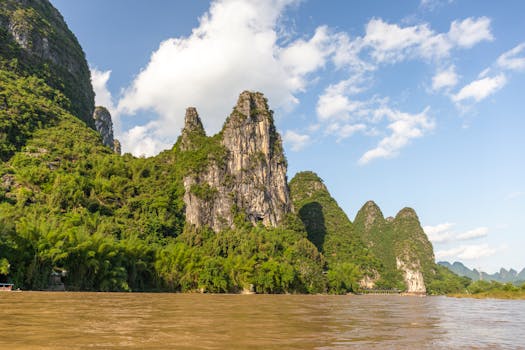 Explore the iconic karst mountains and serene Li River landscape in Guilin, China.