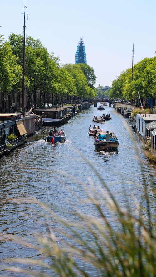 A canal with boats and people on it