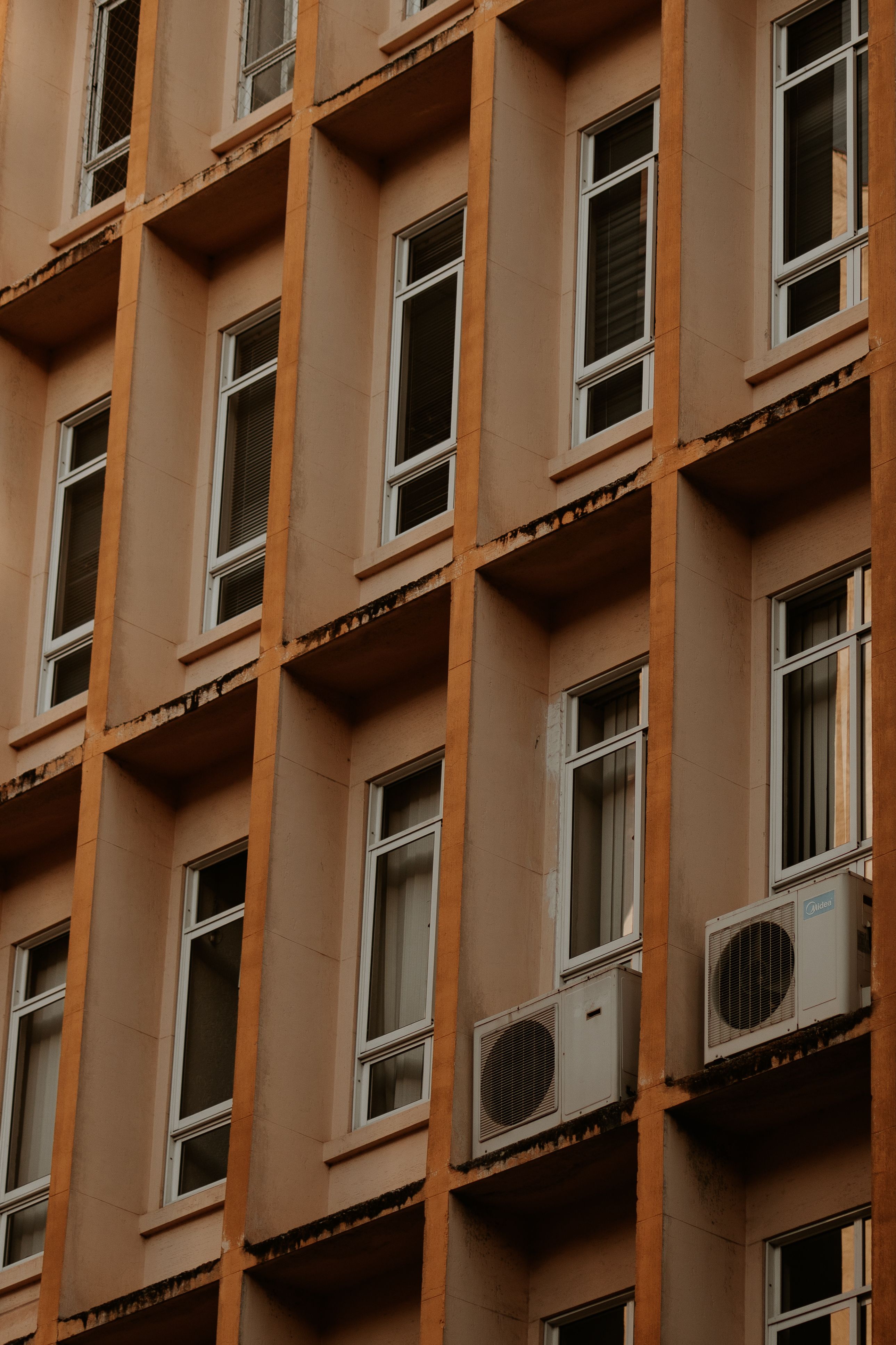 Detailed view of a building facade in Curitiba with air conditioning units.