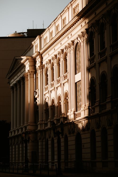 Free Sunlight casts shadows on a classic historical building facade in Curitiba, Brazil. Stock Photo