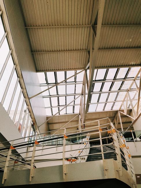 Contemporary interior architecture featuring steel railings and geometric lines.