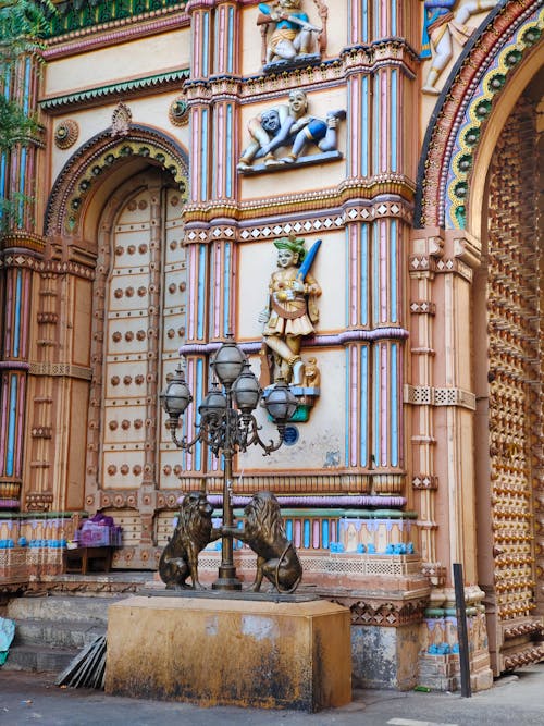 A colorful building with ornate decorations and a statue