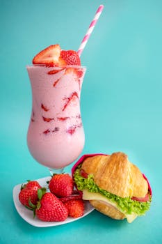在丰富多彩的背景上，供应着美味的草莓奶昔和三明治