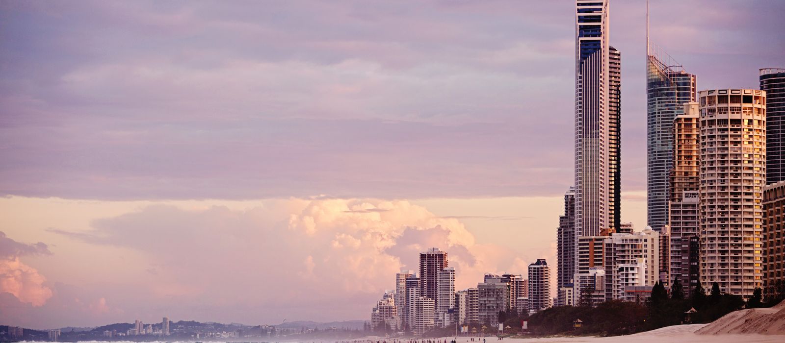 Skyline of Surfers Paradise at sunrise with skyscrapers overlooking the beach in Gold Coast, Australia.