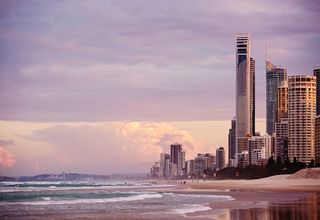 Skyline of Surfers Paradise at sunrise with skyscrapers overlooking the beach in Gold Coast, Australia.