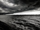 平静的水面上，单色海景映衬着戏剧性的云层，营造出完美的情绪氛围