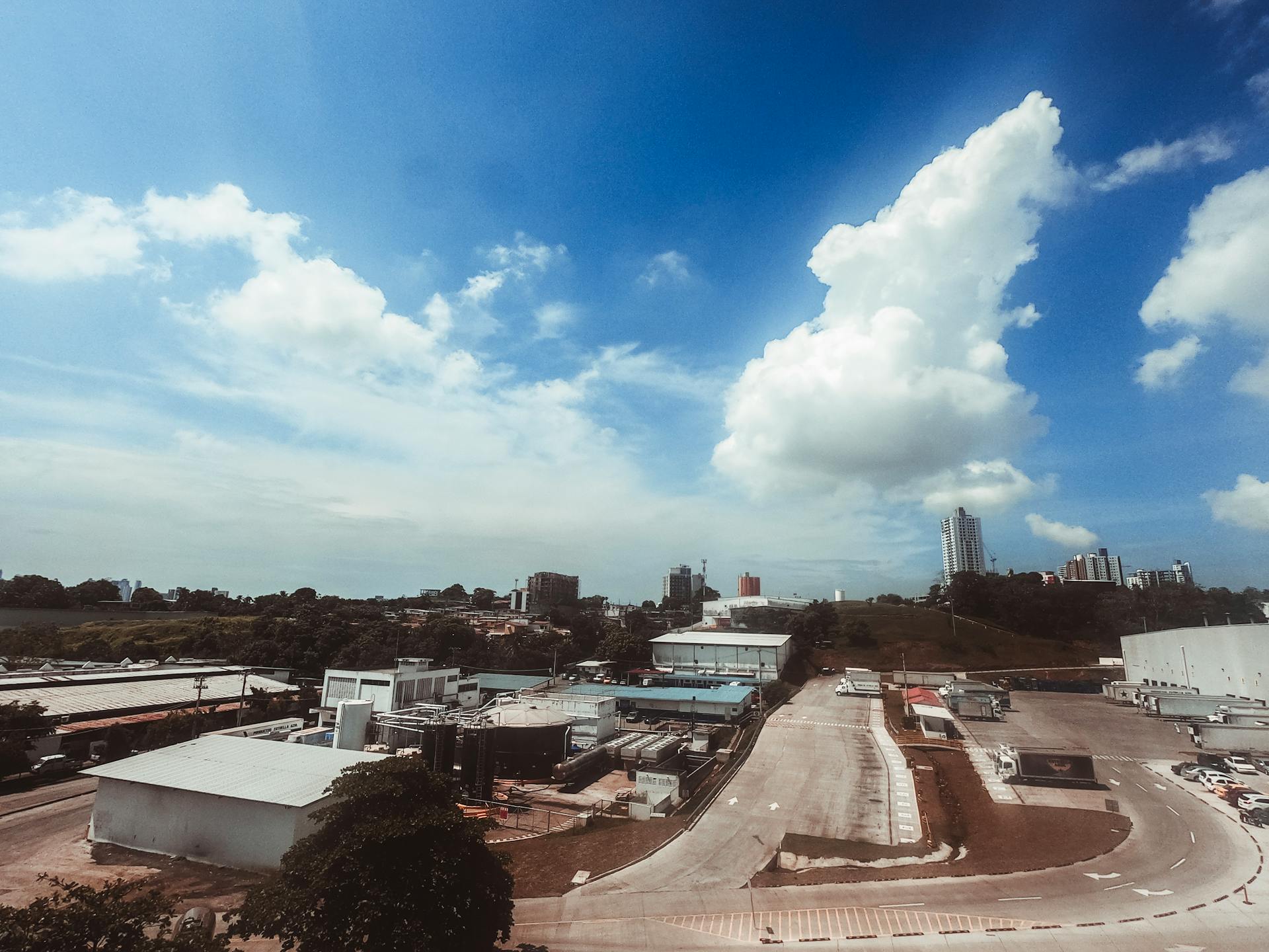 Aerial photograph showcasing a modern industrial area with buildings and clear skies, perfect for urban themed projects.