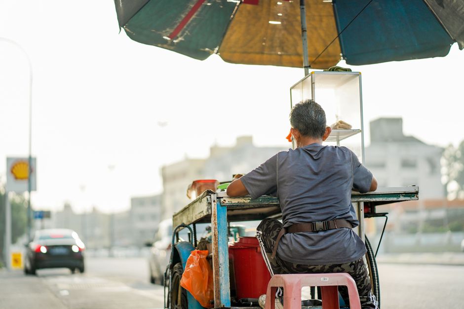 Traveler wearing lightweight clothes exploring a market in Kuala Lumpur, Malaysia
