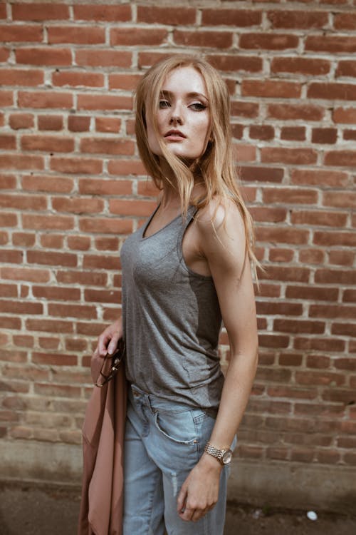 Free Woman Wearing Grey Tank Top And Denim Jeans Stock Photo
