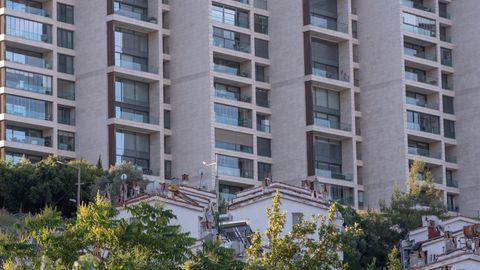 High-rise residential building facade with trees in Bornova, İzmir.