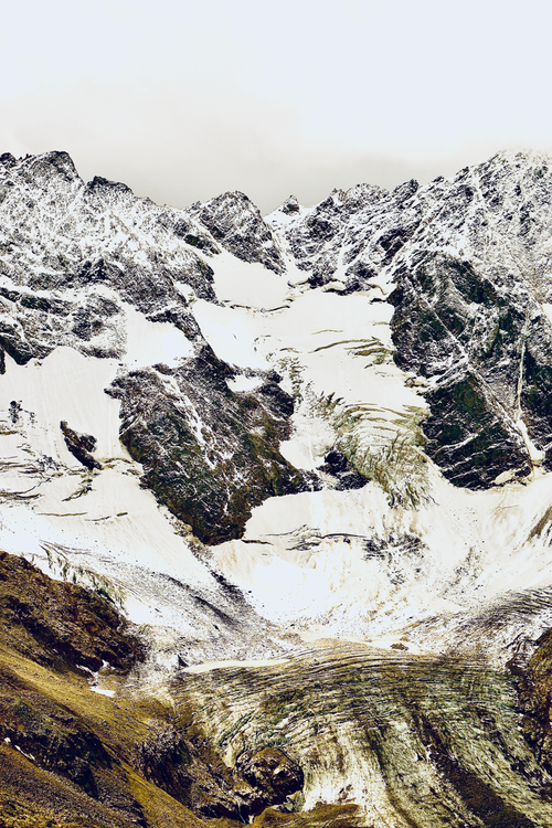 Free A stunning view of a snowcapped rocky mountain glacier in winter, highlighting its majestic icy formations. Stock Photo