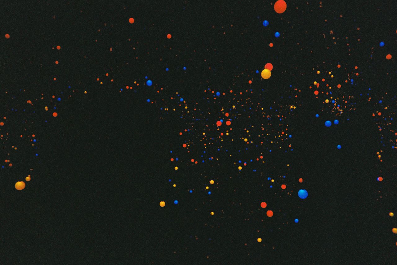colorful abstract pattern with vibrant dots on a black background crea