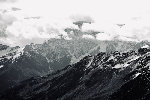 Free Beautiful black and white panorama of snowcapped mountains and clouds. Stock Photo