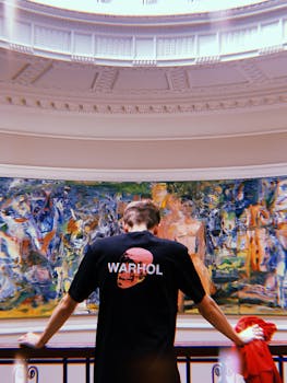 Man in Warhol t-shirt appreciating art at London's Courtauld Gallery.
