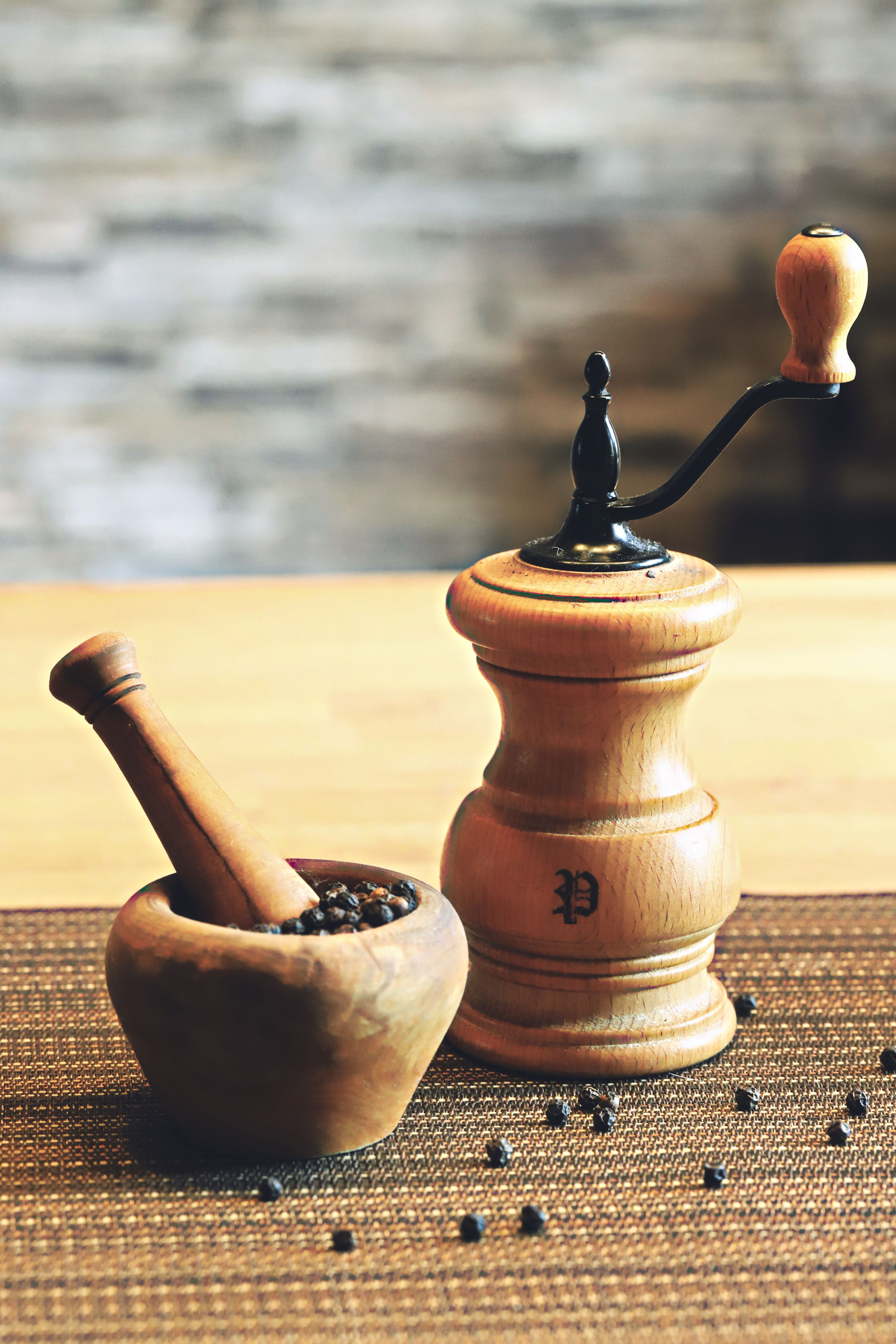 Whole nutmeg in a mortar and pestle, the hardest spice to grind.