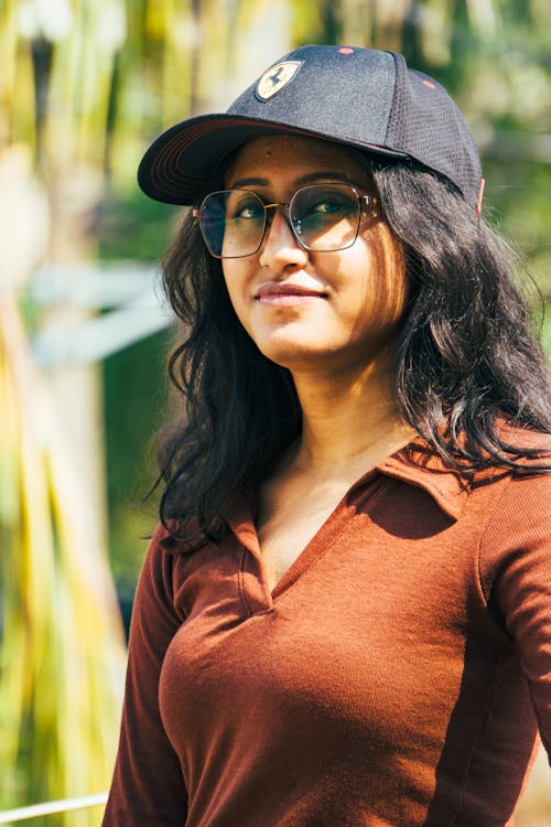 A woman in glasses and a baseball cap