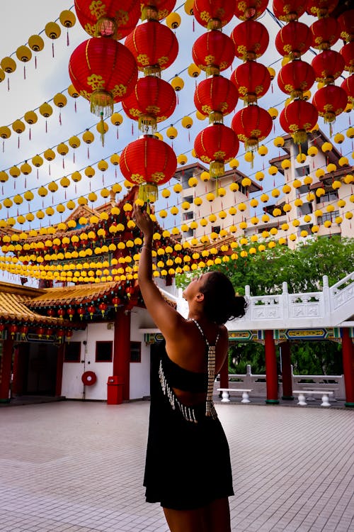 Woman Touching Paper Lantern