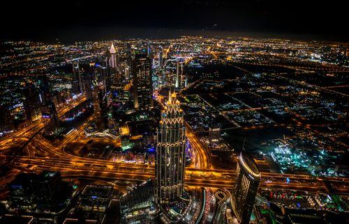 Free High-angle view of illuminated Dubai skyline at night showcasing the vibrant urban cityscape. Stock Photo