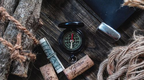 Free A compass and other travel essentials laid out for a vintage adventure feel. Stock Photo